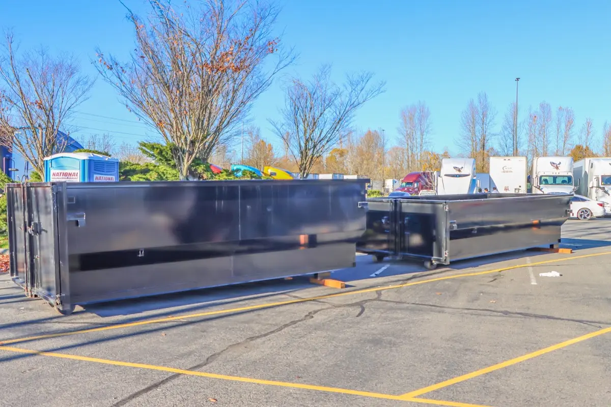 Professional dumpster rental service with roll-off container on residential driveway in Middlesex